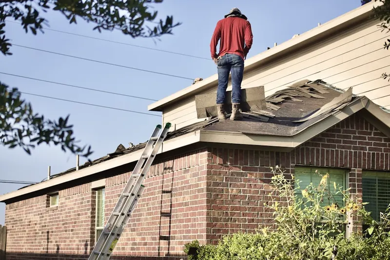 Professional roofer working on a residential roof in Texas Corner